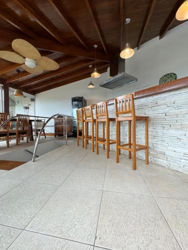a row of chairs and a table in a room at Cobertura com jacuzzi na enseada in Guarujá