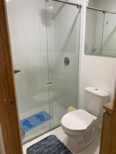 a bathroom with a toilet and a glass shower at Apartamento floral in Tunja