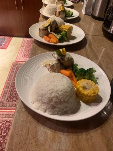 three plates of food on a table with rice and vegetables at Private Oceanfront Fijian Villa Sleeps 8 in Malolo