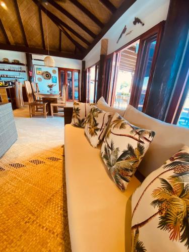 a living room with a couch with pillows on it at Private Oceanfront Fijian Villa Sleeps 8 in Malolo