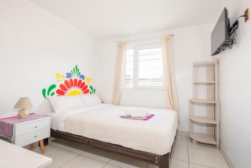 Una cama o camas en una habitación de Retablo Boutique Hotel