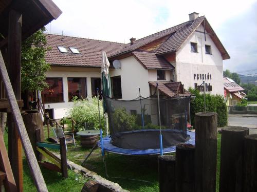 a house with a large tub in the yard at Penzión Marco Polo in Vrútky