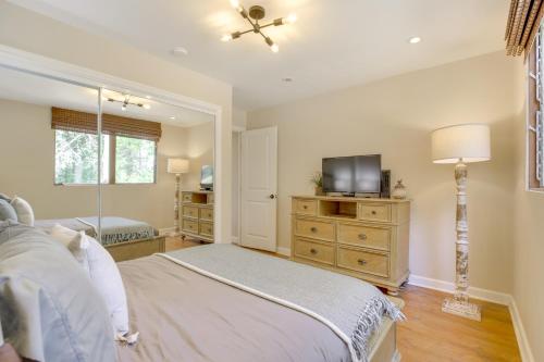 a bedroom with a bed and a flat screen tv at Walk to Lake Arrowhead Village Gem with Lake Access in Lake Arrowhead