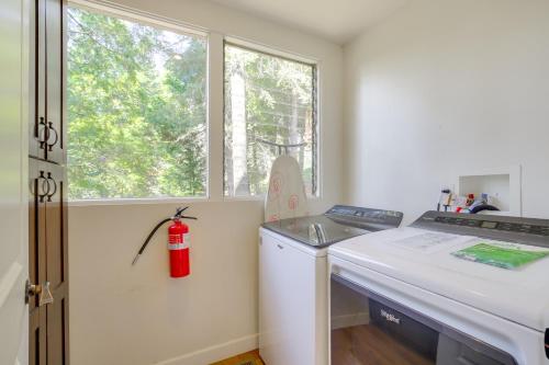 a kitchen with a washing machine and a window at Walk to Lake Arrowhead Village Gem with Lake Access in Lake Arrowhead