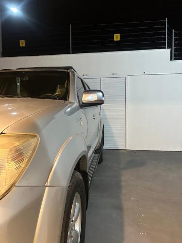 a silver car parked in front of a garage at Casa da Estela in Barreirinhas