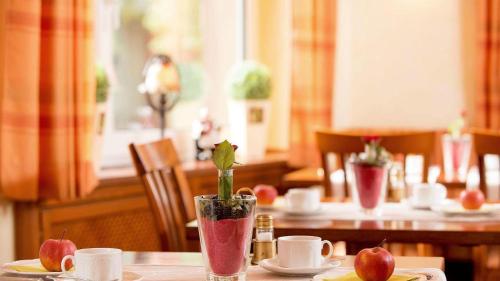 a table with a vase with a plant on it at Haven Hotels - Bochum in Bochum