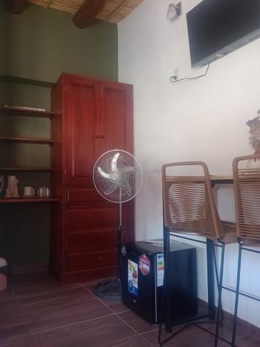 a fan in a room with a table and chairs at Ipay Alojamiento Familiar in Purmamarca