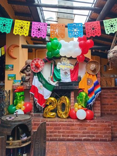 a group of balloons and a sign that says happy birthday at Hostal Santa Isabel in Iza