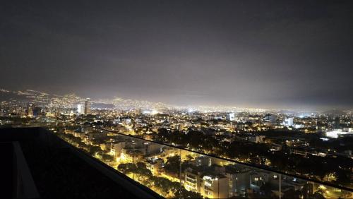 a view of a city at night with lights at Relajar y trabajar en Miraflores in Lima