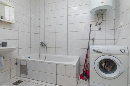 a bathroom with a washing machine and a washer at Apartments and rooms with parking space Podgora, Makarska - 23916 in Podgora