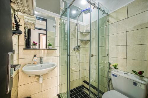 a bathroom with a sink and a toilet and a glass shower at Chic & Cozy Retreat in Agadir in Agadir