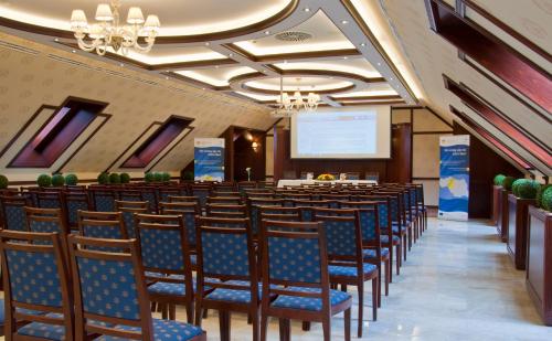 a conference room with chairs and a podium at Centrum Hotel in Debrecen
