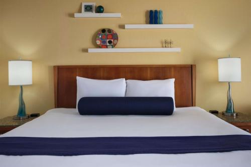 a bedroom with a large bed with two lamps at Hotel Zico, BW Signature Collection in Mountain View