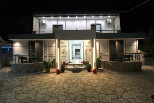 a house with a lit up front at night at Vila Reni Risi in Ksamil