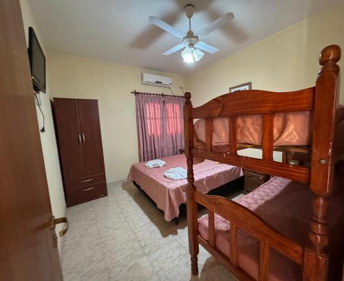 a bedroom with two bunk beds and a ceiling fan at Centricos Departamentos in Termas de Río Hondo