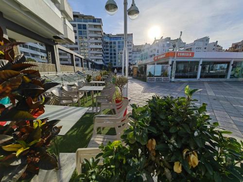 a group of tables and chairs on a city street at City Bleu Maroc in Tangier