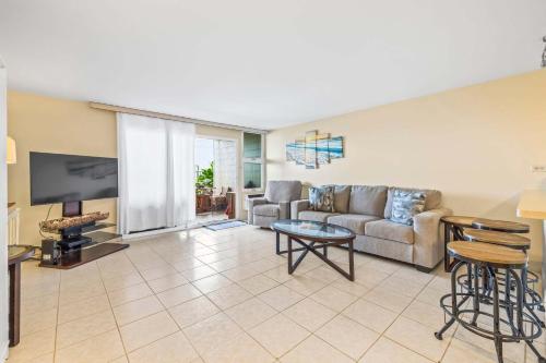 a living room with a couch and a table at Amazing Beachfront Condo by Pool in Hauula