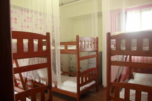 a room with three bunk beds and a window at Mozhu B&B in Hualien City