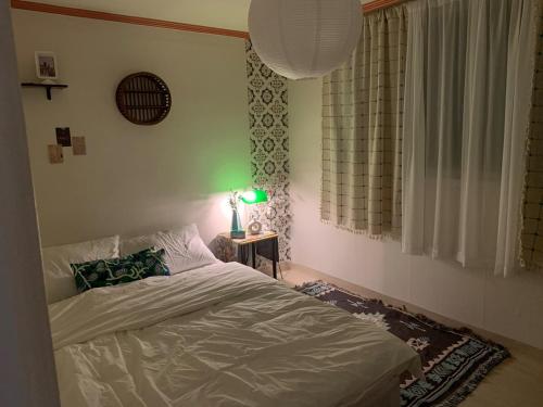 a bedroom with a bed and a lamp on a table at STAY MOMENT #Suwon in Suwon