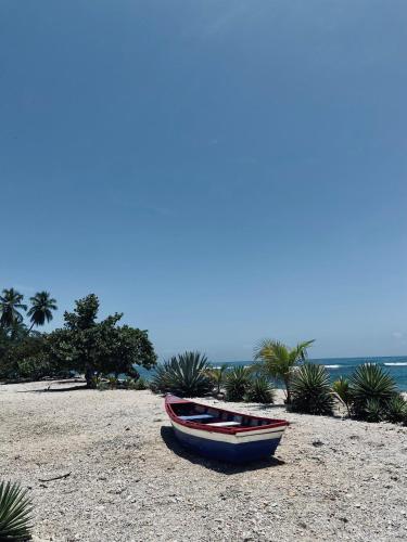 a small boat sitting on a sandy beach at Hotel Al Mare in Santa Cruz de Barahona