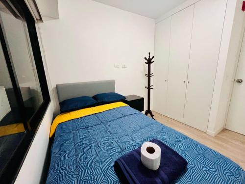 a bedroom with a bed with a roll of toilet paper on it at Hermoso departamento en el Centro de Lima in Lima