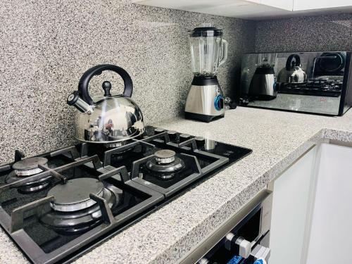 a kitchen stove top with a tea kettle on it at Hermoso departamento en el Centro de Lima in Lima