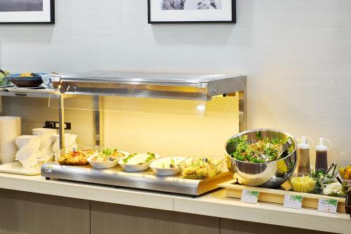 a buffet line with different types of food on display at キップホテル湘南藤沢 in Kugenuma