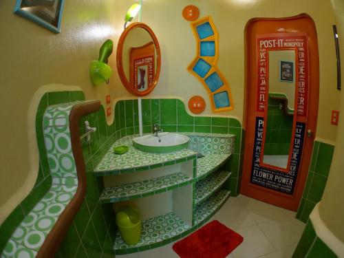 a toy bathroom with a sink and a mirror at Takatuka Beach Resort in Sipalay