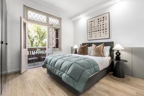 a bedroom with a large bed and a window at Simpson Street Apartments by Urban Rest in Melbourne