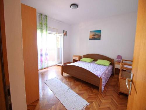 a bedroom with a bed and a large window at Apartment in Dinji ka by the Beach in Dinjiška