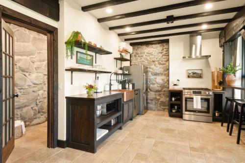 a large kitchen with a stone wall at Horsefeathers Hotel in Hood River