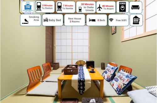 a dining room with a table and chairs with signs above it at 大阪指定特区民泊小田別荘なんば店OdaVillaNamba in Osaka