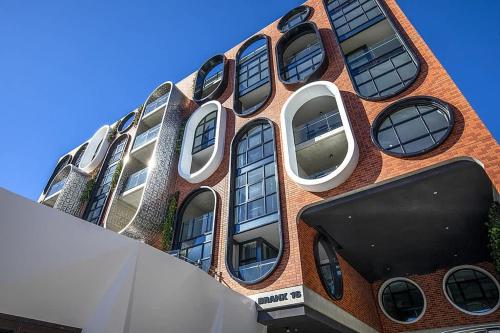 a building with many windows on the side of it at 2 Bedroom Luxury & style in the heart of Braddon in Braddon