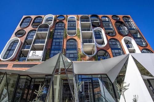 a tall brick building with many windows on it at 2 Bedroom Luxury & style in the heart of Braddon in Braddon