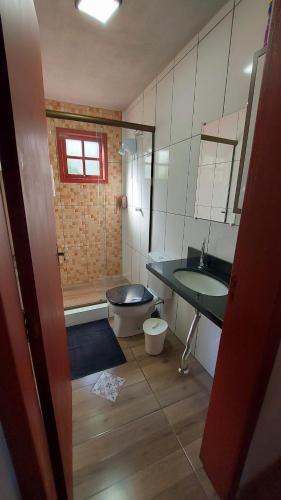 a bathroom with a sink and a toilet at Recanto Pôr do Sol in Nova Petrópolis