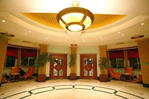 a large lobby with a chandelier on the ceiling at Hotel Intourist Palace Batumi in Batumi