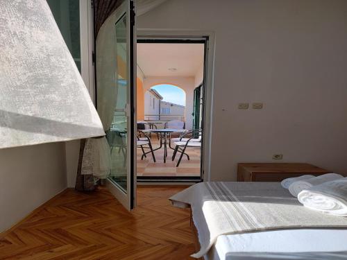 a bedroom with a bed and a view of a patio at Apartment in Ra anac near Beach Rtina in Ražanac