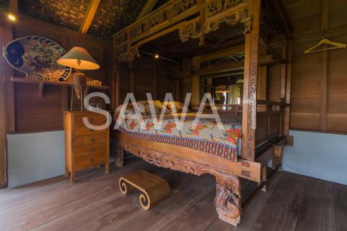 a bed in a room with a table and a lamp at Rumah Lereng Bandung in Bandung