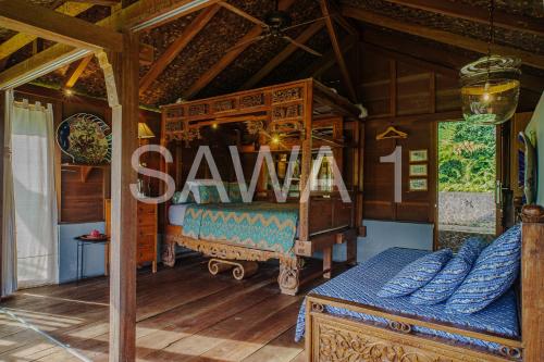 a bedroom with a bed with a sign saying sahiba at Rumah Lereng Bandung in Bandung