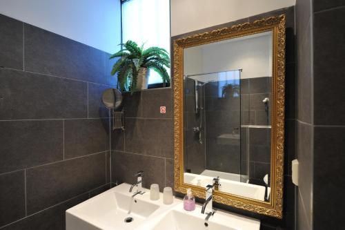 y baño con lavabo y espejo. en The Posthoorn Amsterdam, en Ámsterdam