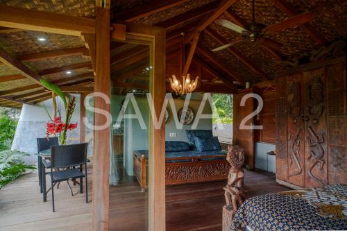 a bedroom in a villa with a bed and a table at Rumah Lereng Bandung in Bandung