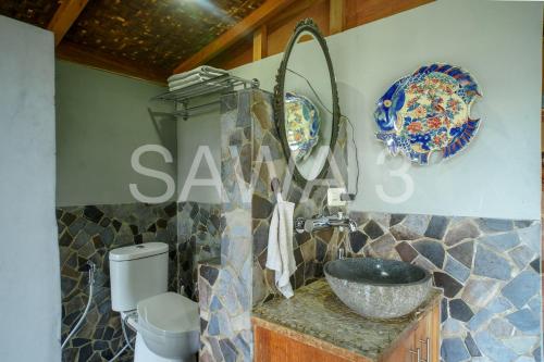a bathroom with a sink and a plate on the wall at Rumah Lereng Bandung in Bandung