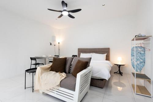 a bedroom with a couch and a bed with a ceiling fan at Casa Bella - Private Studio Ipoh - Pet allowed in Ipoh