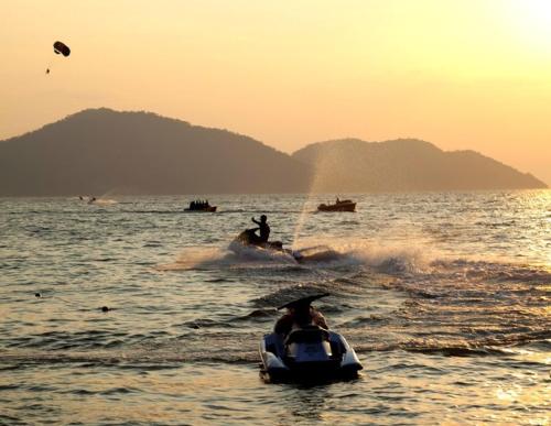 a group of people on a boat in the water at HMI Roomstay in Pantai Cenang