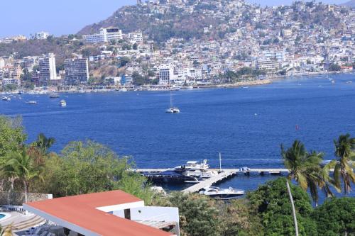 a view of a harbor with boats in the water at Hotel Aristos Acapulco in Acapulco
