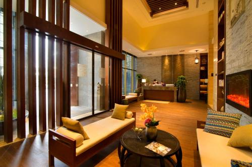 a living room with a couch and a table at SSAW Boutique Hotel Hangzhou Wildwind in Hangzhou