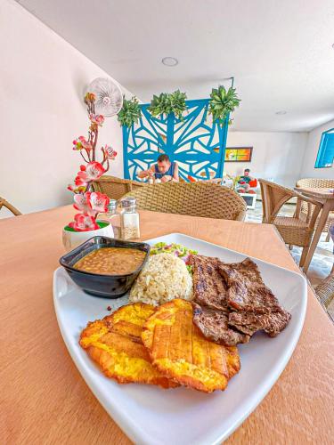 a plate of breakfast food on a table at Hotel Casamart Rodadero in Santa Marta