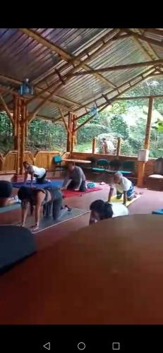 a group of people doing yoga in a room at Hostel For Machetà Climbers Colombia in Machetá