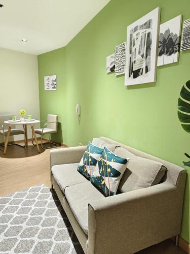 a living room with a couch and a table at Gramercy Residences Makati by Christine Suites PH with Balcony in Manila