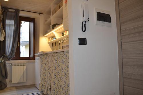a small kitchen with a refrigerator in a room at Home Love Home in Casasco Intelvi
